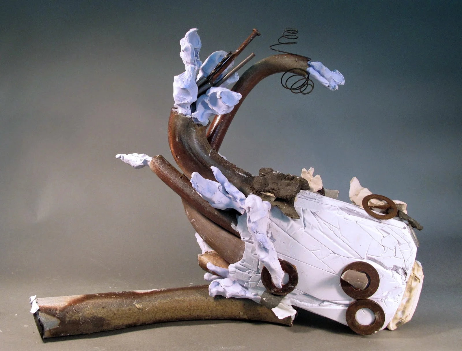 Sara Fine-Wilson, Milk Bone Spewing , clay, plaster, silicone and found objects, 17"x17"x6" 
