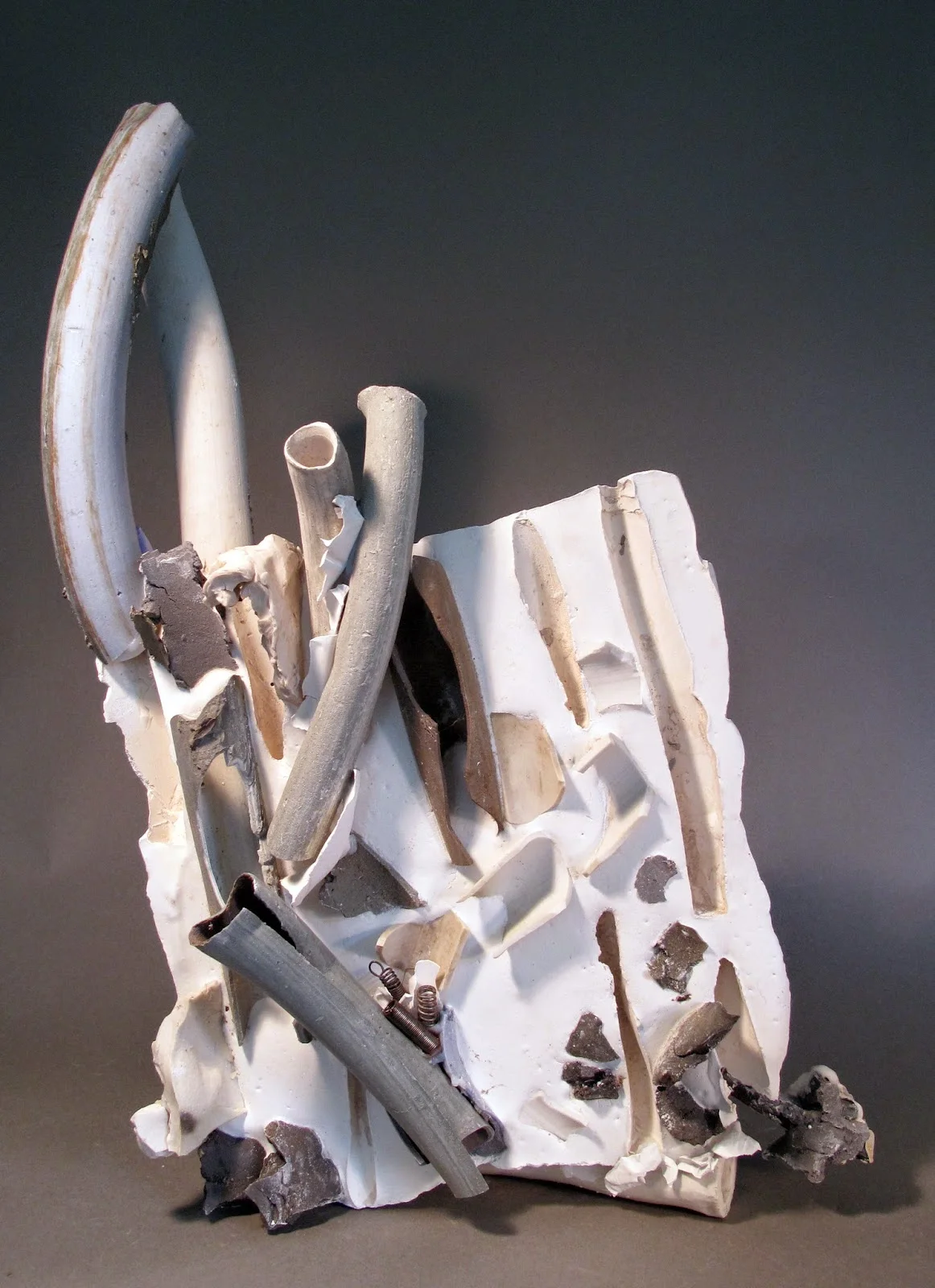 Up and Over , clay, plaster, silicone, metal and found objects, 20"x11"x7"