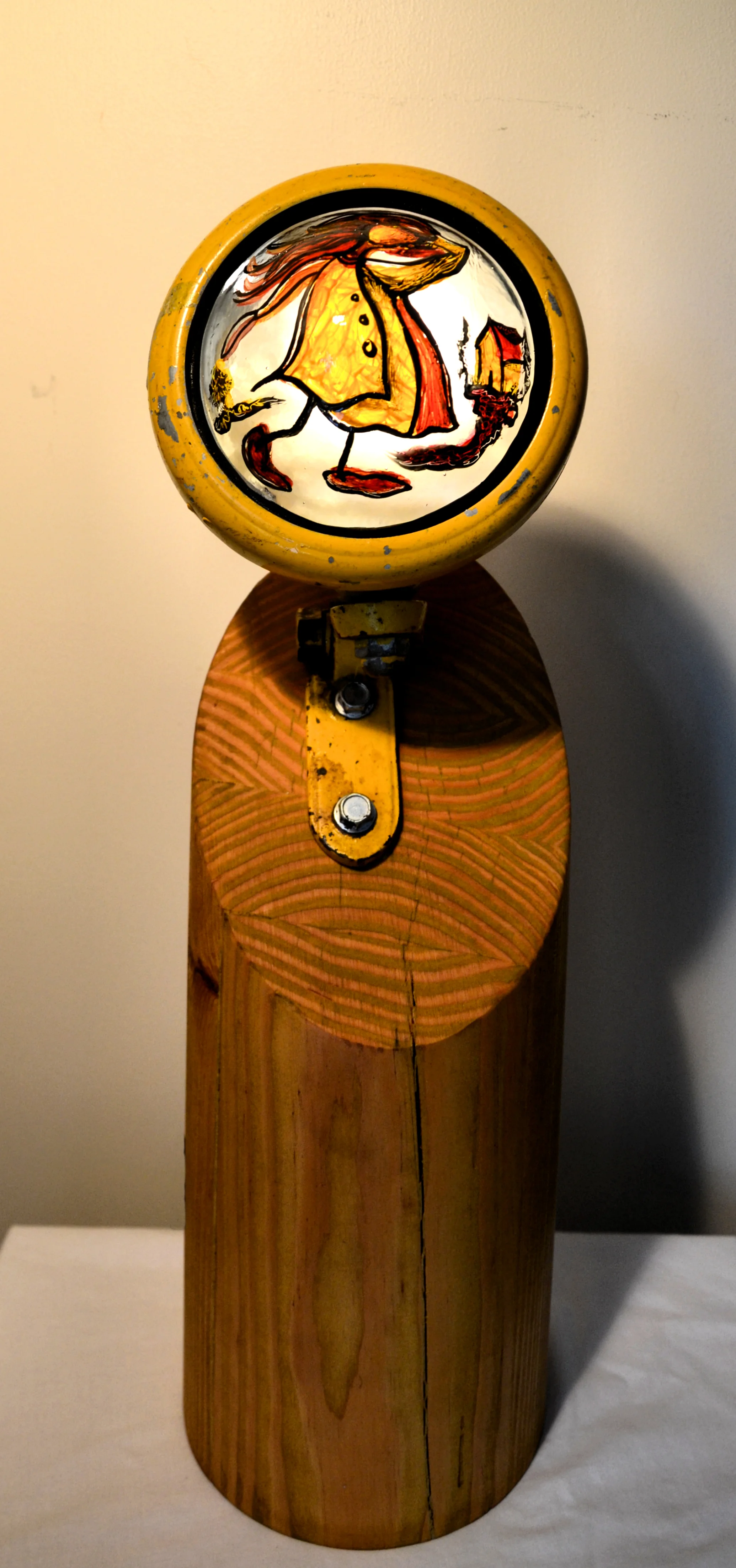 Anita Loomis, Searching for Home, tractor light housing, repurposed/turned wood, LED, and slumped/painted glass, 7x7x23