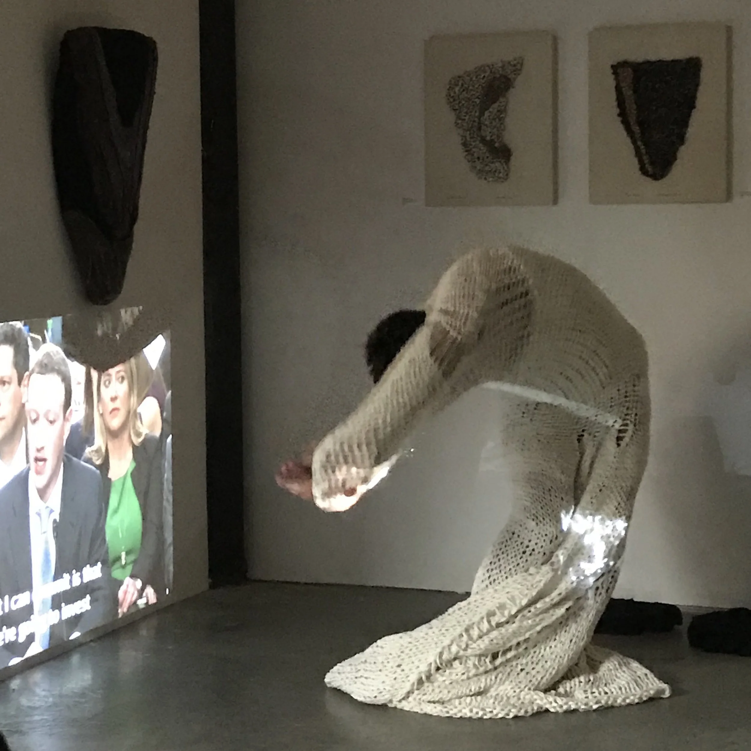 Image: Choreographer and fiber artist Alexander Davis performs an experimental work against the backdrop of Unspooled , an exhibit of work by Joel Moskowitz and Sylvia Vander Suis.