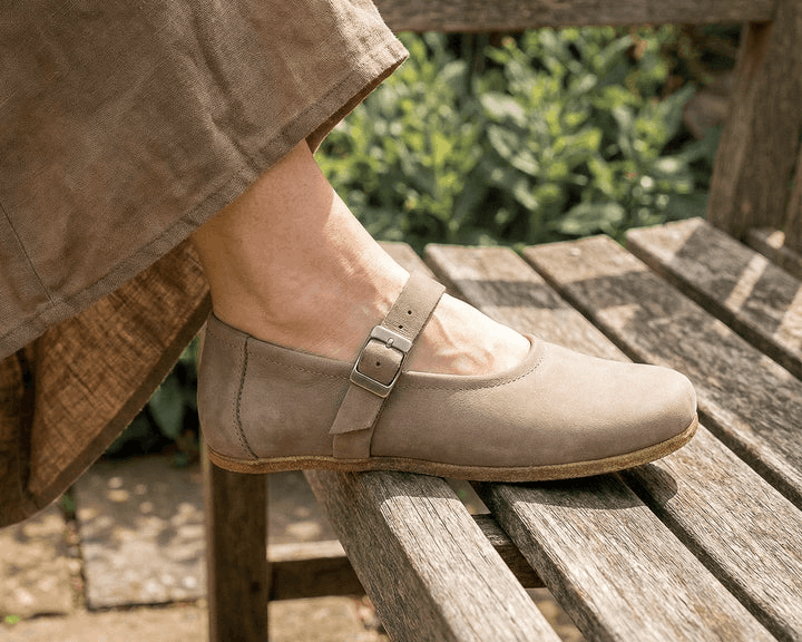woman's foot in rhizal nara style grounding shoe leaning against wooden bench