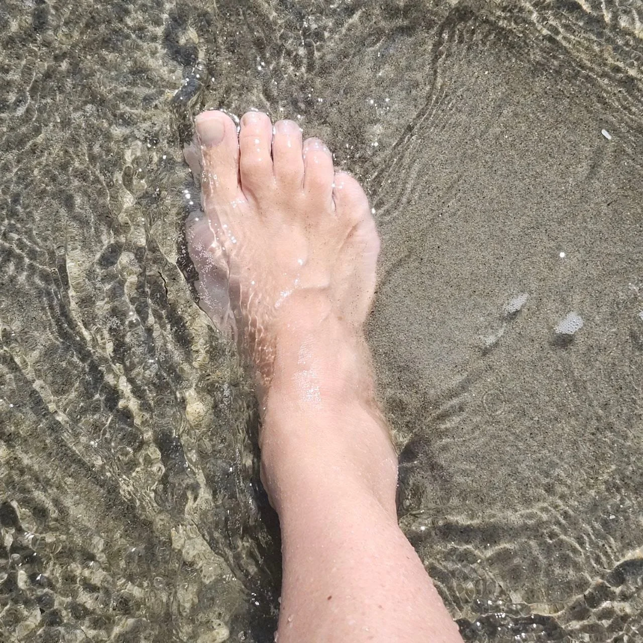 grounding in barefoot wading in the ocean at the beach