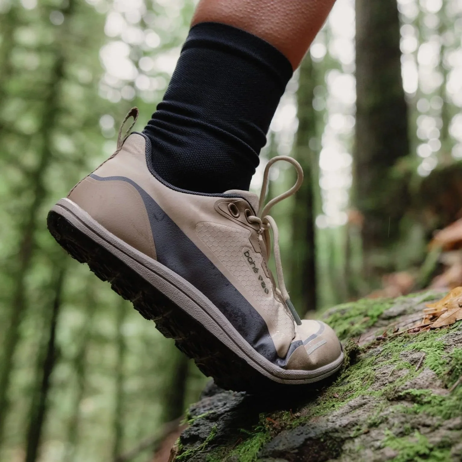 wearing bahe rewild adapt waterproof grounded trail shoe in the woods
