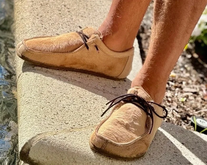 man wearing rhizal cowhide and sheepskin miro grounding shoes poolside on concrete