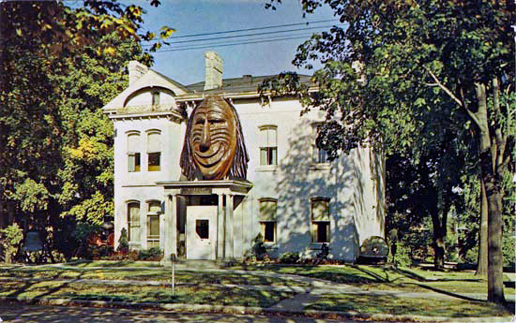 Brant County Museum in 1960. The Aboriginal Mask was added over the front door in 1959. An addition was added to the north side of the building (left side) and opened in November-1966. The Mask was removed from the museum in 1996. Image courtesy of the Brant Historical Society