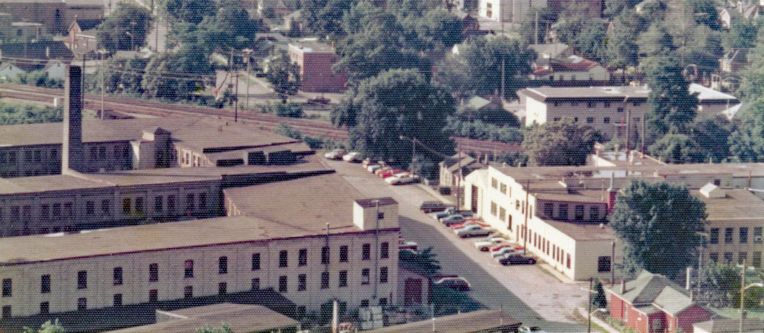 Brantford Carriage / Bay State Abrasives Factories 1976 - Brantford Carriage Company (left foreground) opened this factory on Pearl Street in 1888. The company was acquired by the Cockshutt Plow Company in 1911. By the late 1940s this factory had become a parts warehouse for the Cockshutt Plow Company. The building was demolished in 1984 because it was structurally unsound. White Farm Equipment declared bankruptcy in 1985. Saorsie Co-operative Homes now occupies the site. This redevelopment started in 1989. Bay State Abrasives (right building) began at this location as Brantford Emery Wheel Company in 1910. It became the Brantford Grinding Wheel Company in 1920. Bay State Abrasive acquired the factory in 1939. The factory was closed in 1989 by Florida-based Abrasive Industries when production was moved to the U.S. I mage courtesy of the Brant Historical Society