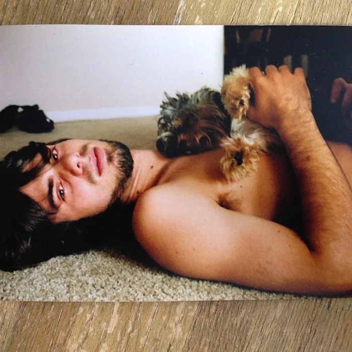 He scoured the town for a dog or a cat (any cute thing, really) for the photo shoot. Lindsay had been told that a portrait of him looking really sensitive would win over the woman of his dreams. Lindsay and his buddy Chris (the 'Tog) spent 2-and-a-half days working the poses. The terrier later suffered PTSD; the 36x48 print Lindsay sent to Zara was returned-to-sender; Chris went on to work at the local prison; and Lindsay became a famous TV Doctor.