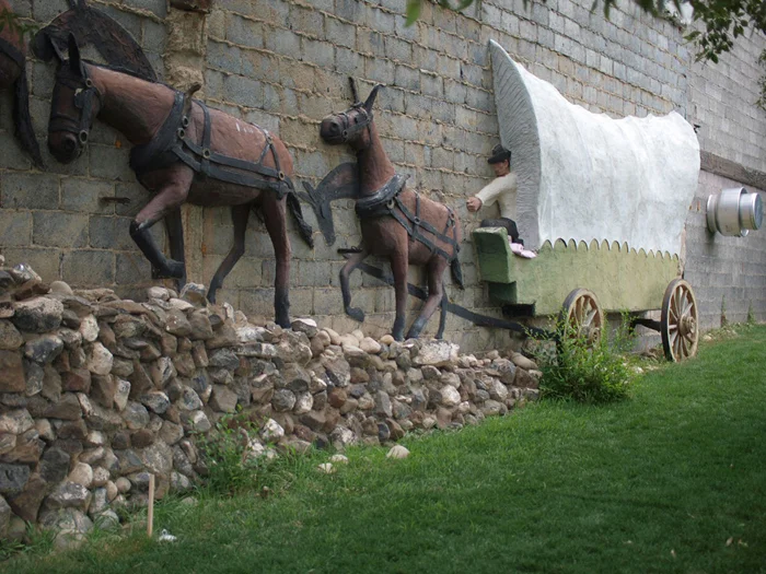 A frontier wagon on the side of a building 