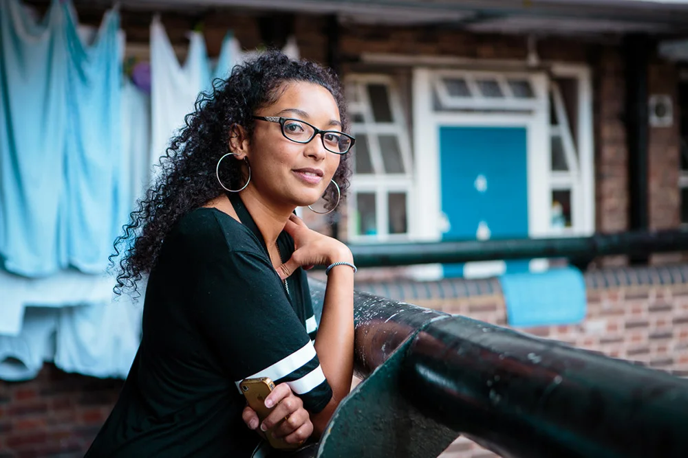 Raquel outside her flat, Hackney Downs, 2015 Now 24 years old, Raquel is at a bit of a cross roads in terms of her future, she works in event management but as a warm chatty person feels she'd be better off in a career related to helping people. She loves her neighbourhood and is happy that Hackney has become cleaner and quieter in recent years but is upset that it is at the expense of long time local residents being priced out of their own homes and business, and that the rich cultural mix of people is being threatened. "That's what I love about Hackney the different types of people, it's literally everyone from everywhere."