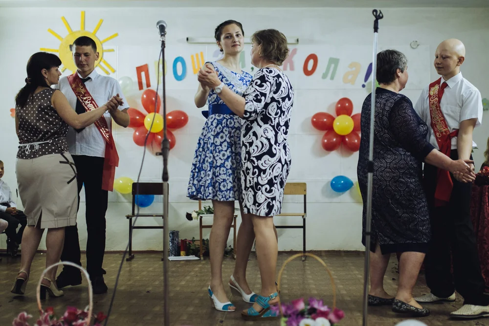 Middle school graduation day in Rotari. The graduation class has only three people. Unlike in the city schools, in the villages children have no option to go to high school. This is because the number of children in rural areas is too low. 
