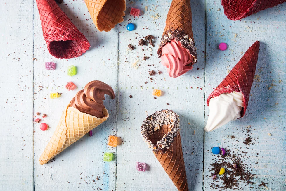 In this shot that was executed for Yogurtbay, the theme was color pop, to display all the variety of waffles that are sold at the store with a mix and match of different yogurt flavors. A textured light blue plank is used as the background, carefully placed waffles and garnishes crumbled and sprinkled around the gaps. S tyled by Amrita Rana, Life ki recipe Light : Strobe light with softbox modifier and white card for subtle bounce.