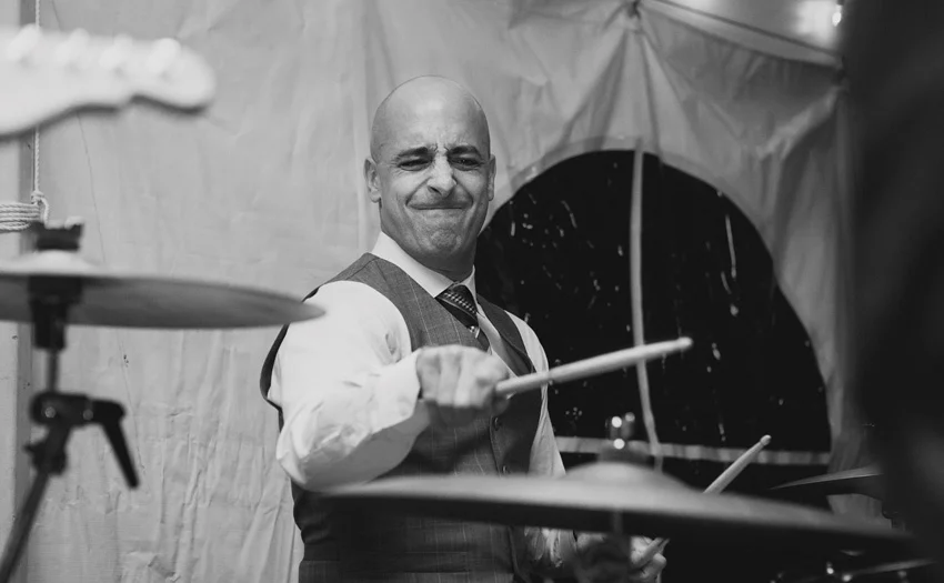 groom playing drums