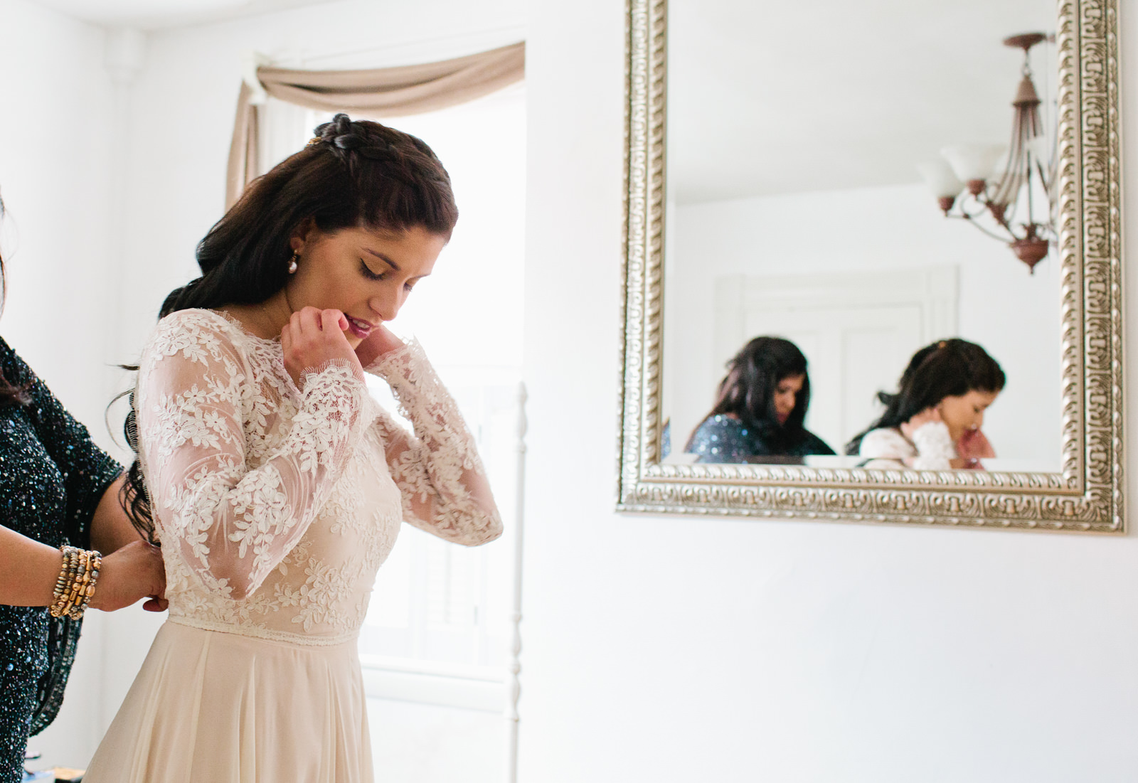 a bride gets dressed for her maine wedding