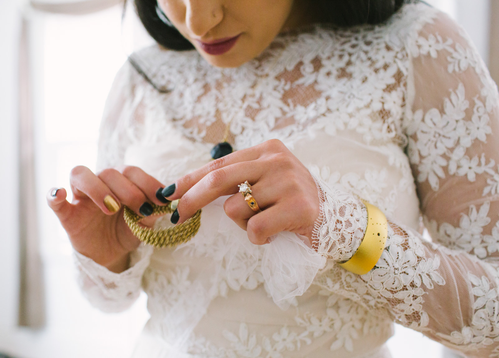  bride putting jewelry on 