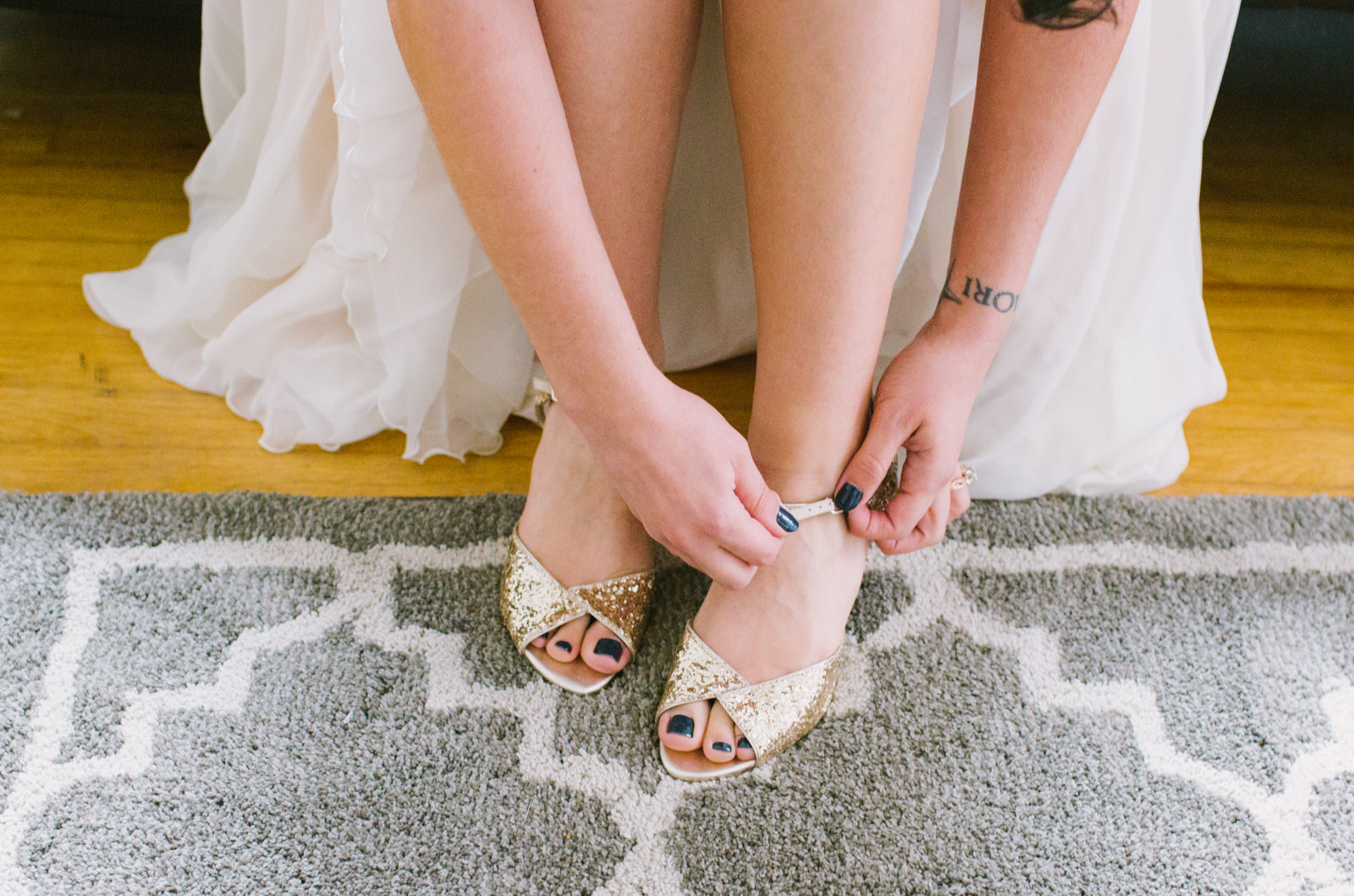  bride putting shoes on before wedding 
