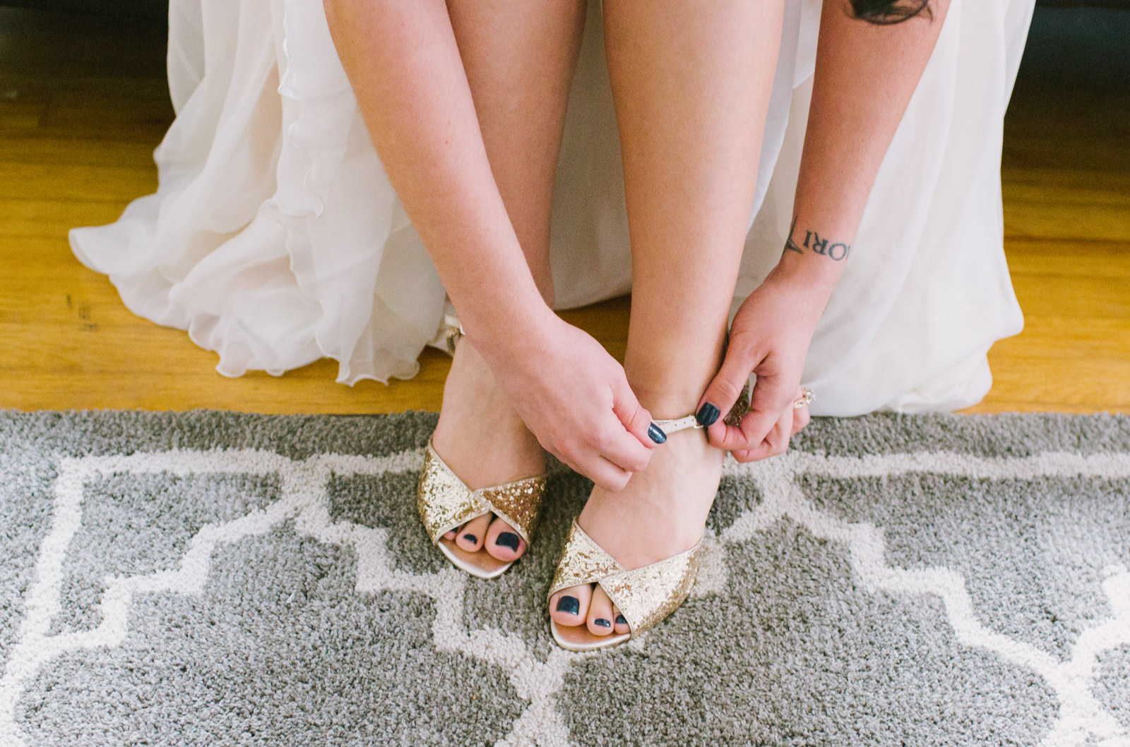 bride putting shoes on before wedding