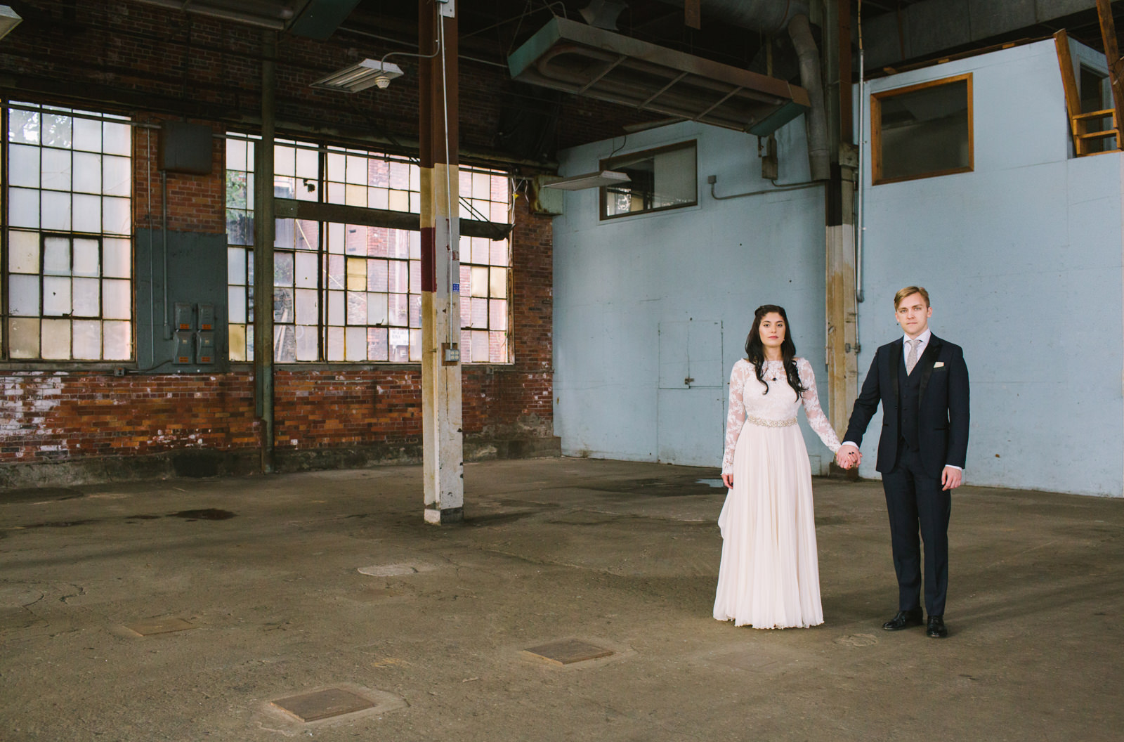  a bride and groom at the portland company complex in maine 