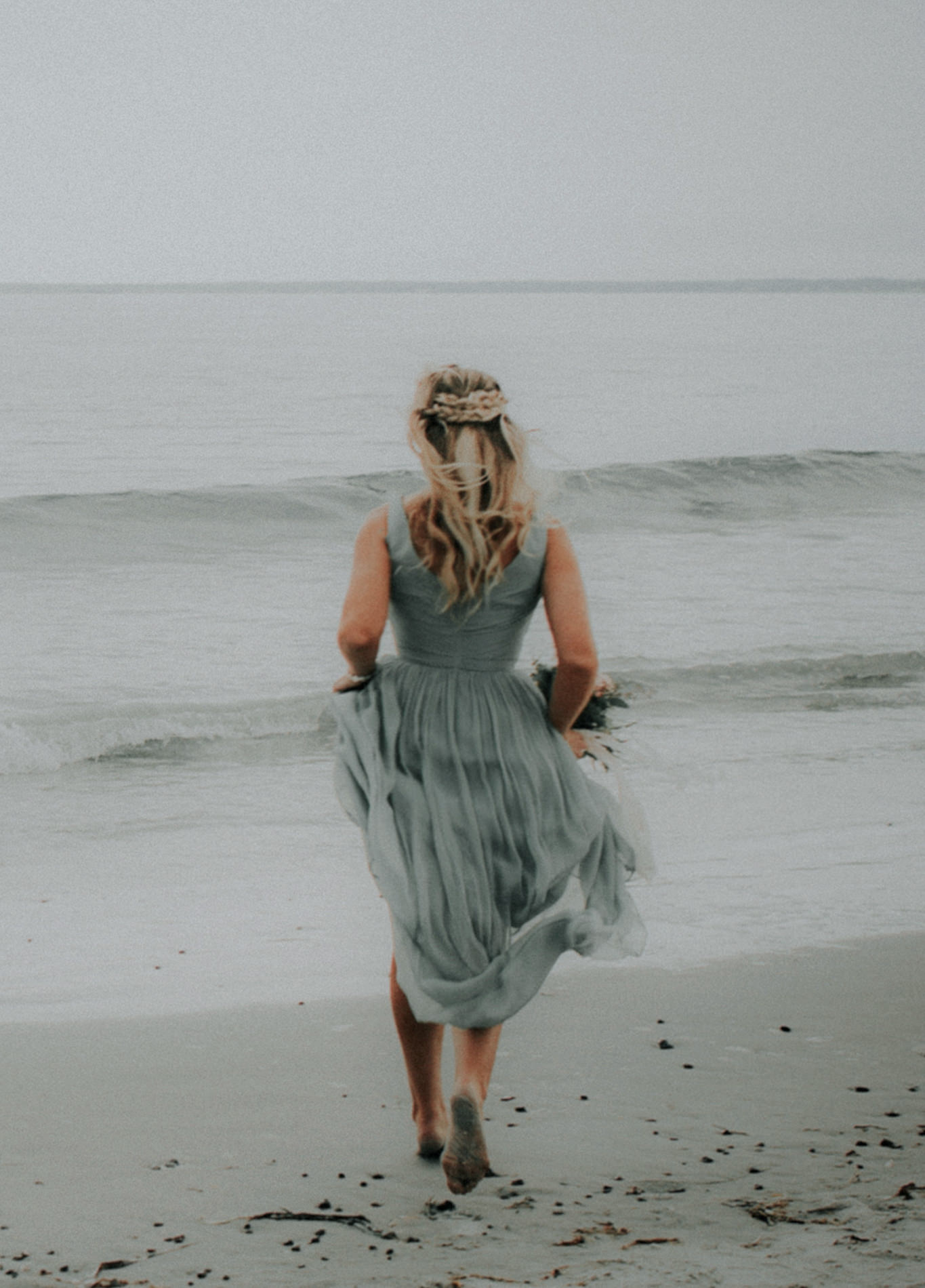  bridesmaid running towards the ocean in maine 