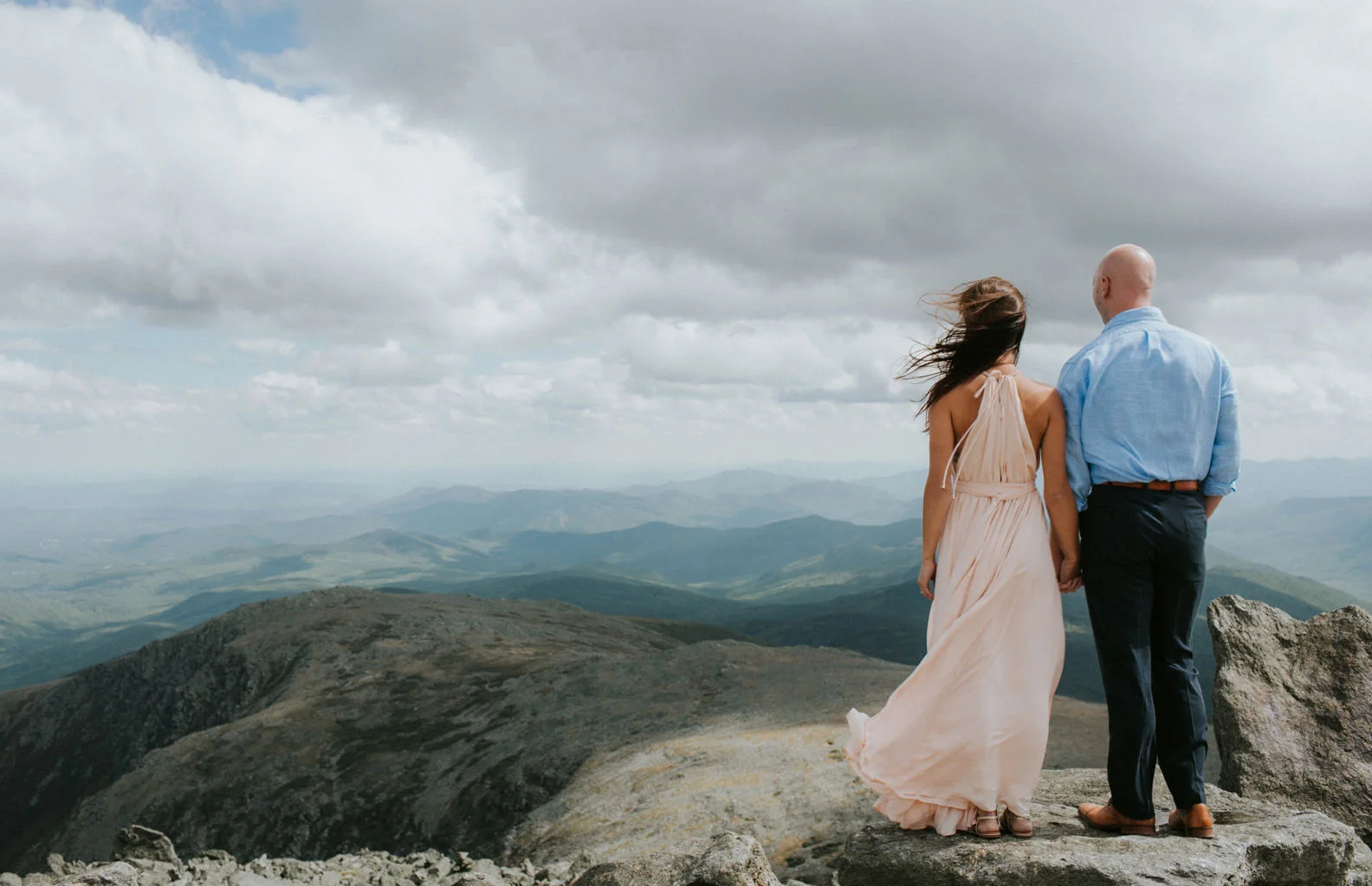 couple looks out in distance on the white mountains