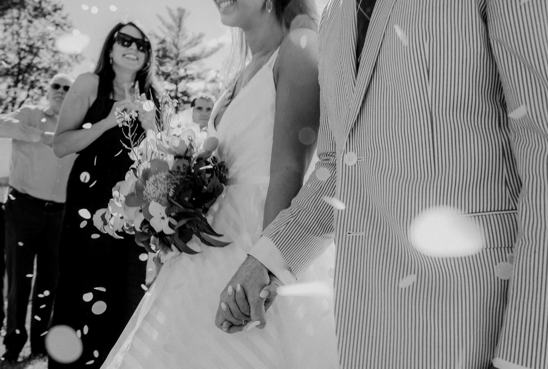 A bride and groom are just married and walk through confetti