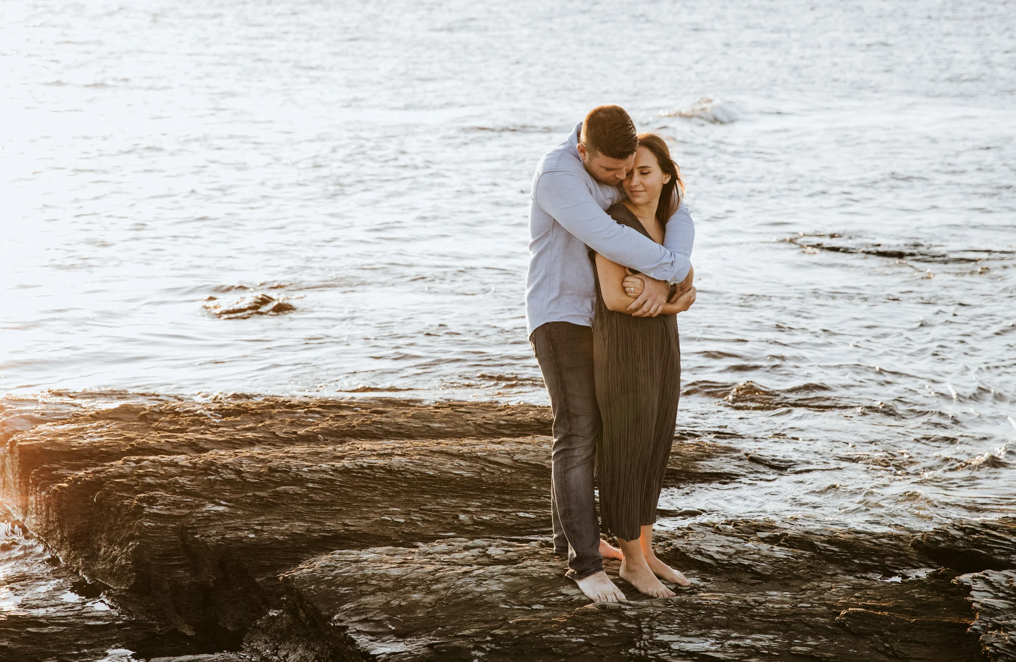 A couple snuggles during their engagement photos