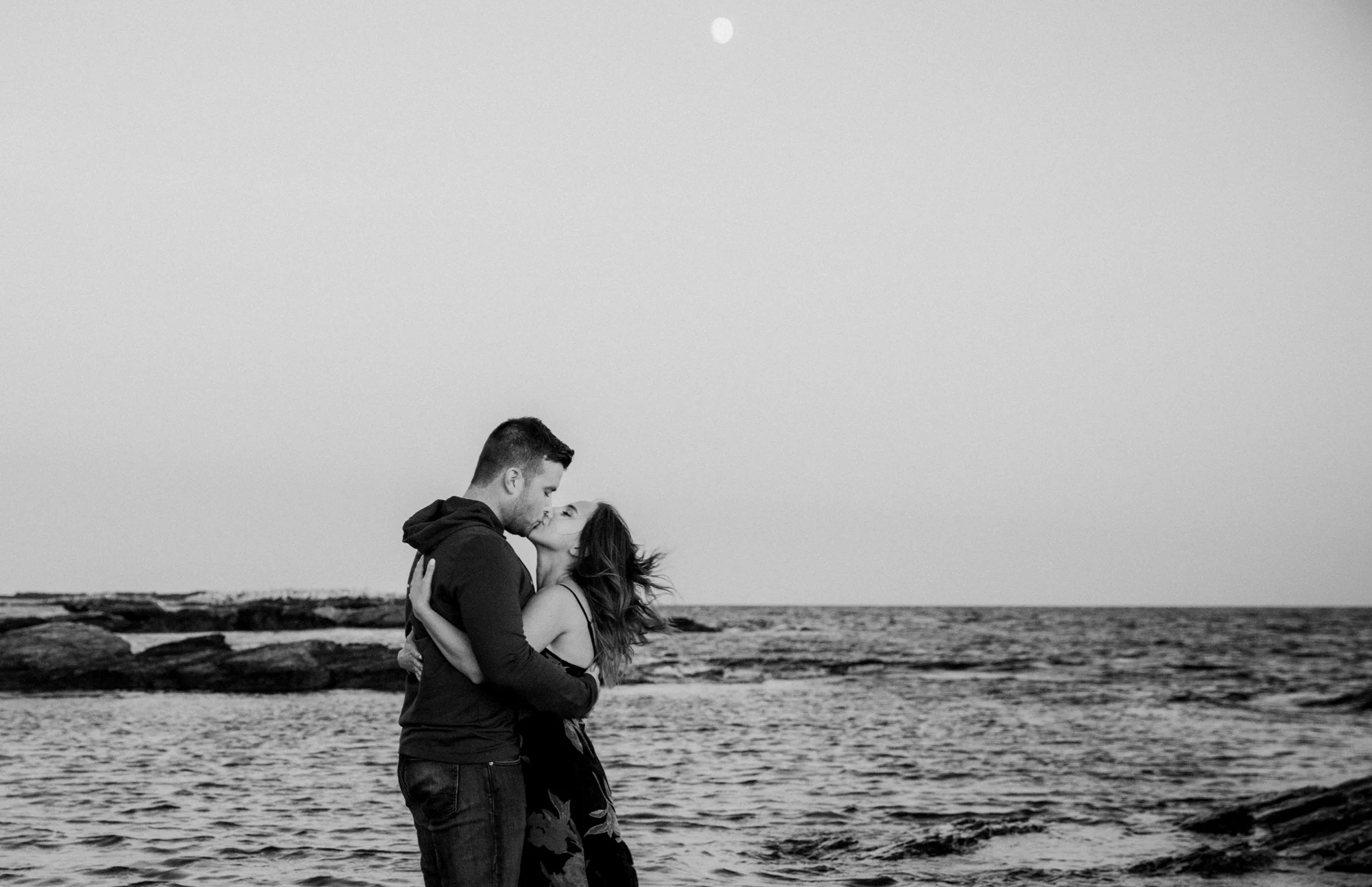 A couple embraces under the moon light