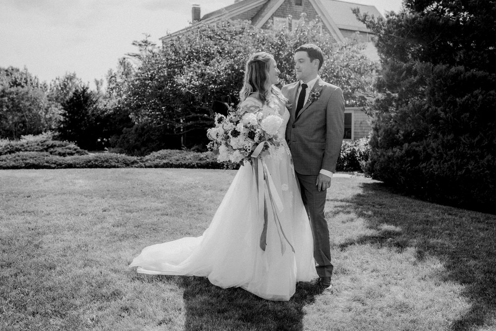  A bride and groom on the lawn of the inn at their mid coast Maine wedding 