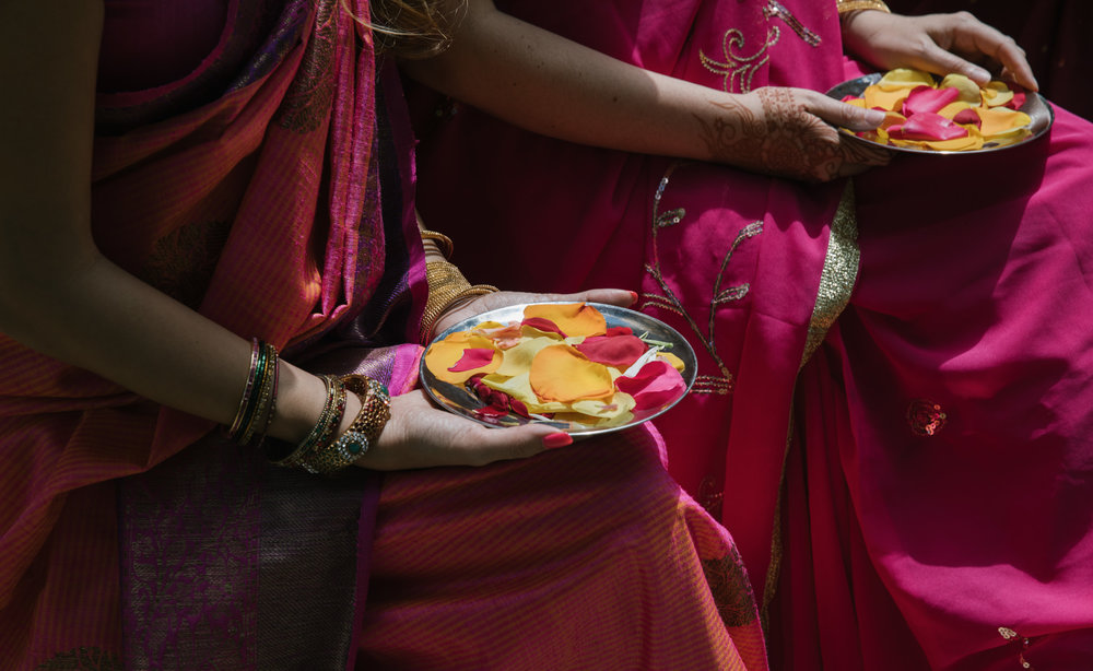  Bridesmaids holding plates of flower petals at an Indian wedding ceremony in Maine 