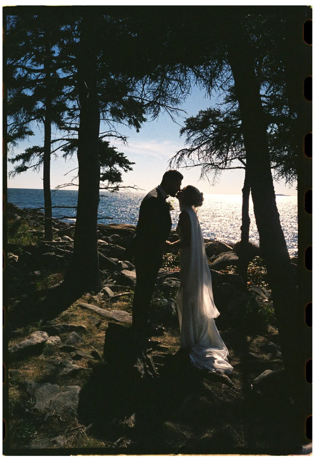 A couple kissing after their vows at Newagen Seaside Inn, photographed on film