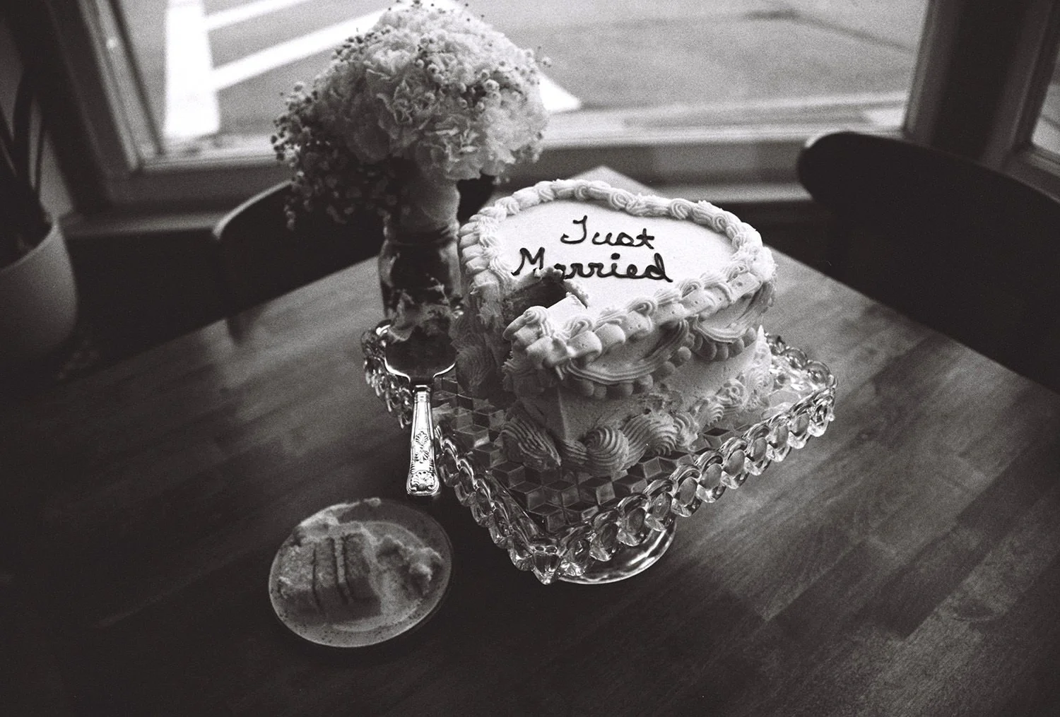 A heart shaped cake with a piece cut out in black and white film
