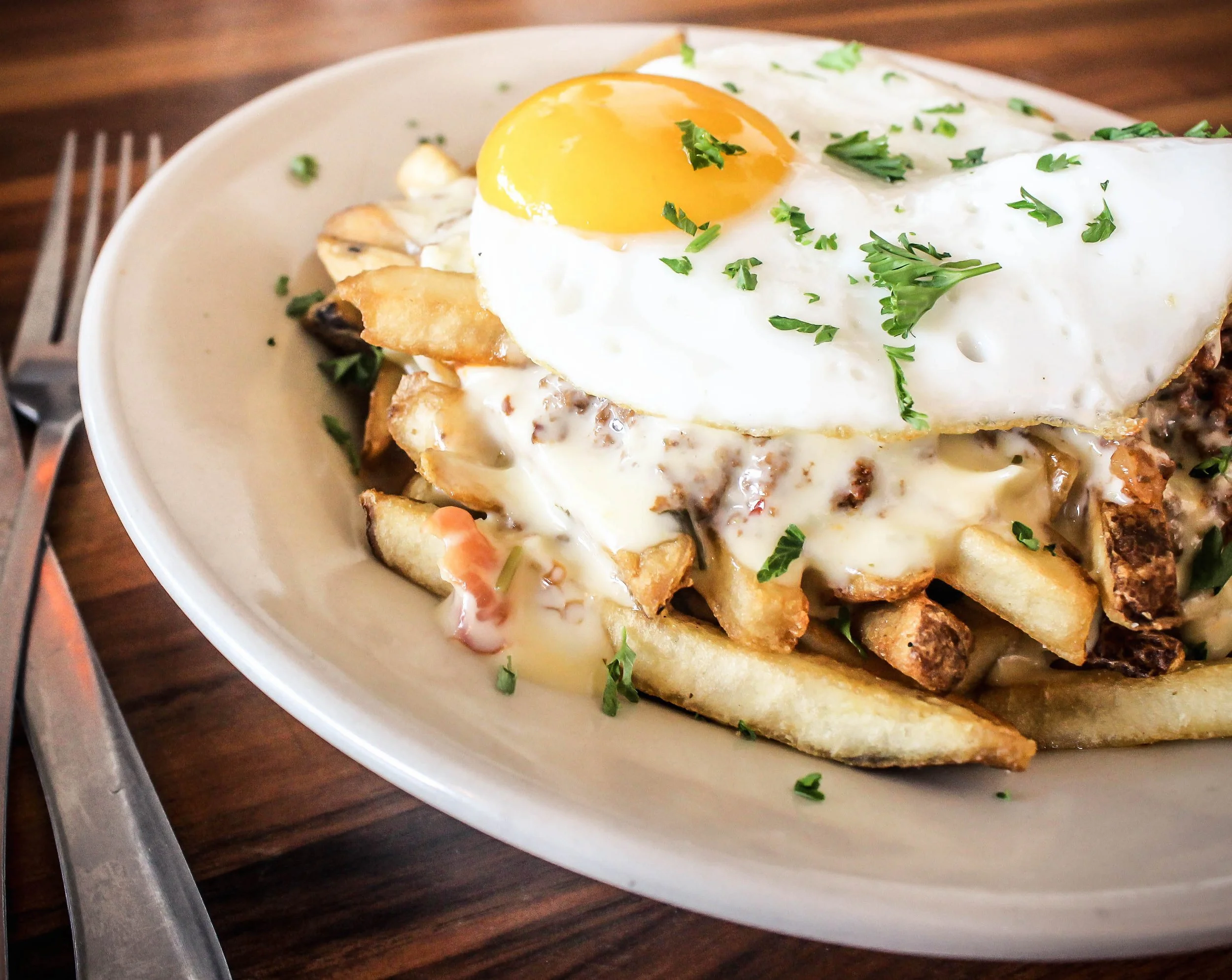 Chili-Queso Fries with Akaushi beef chili and a sunny-side up egg