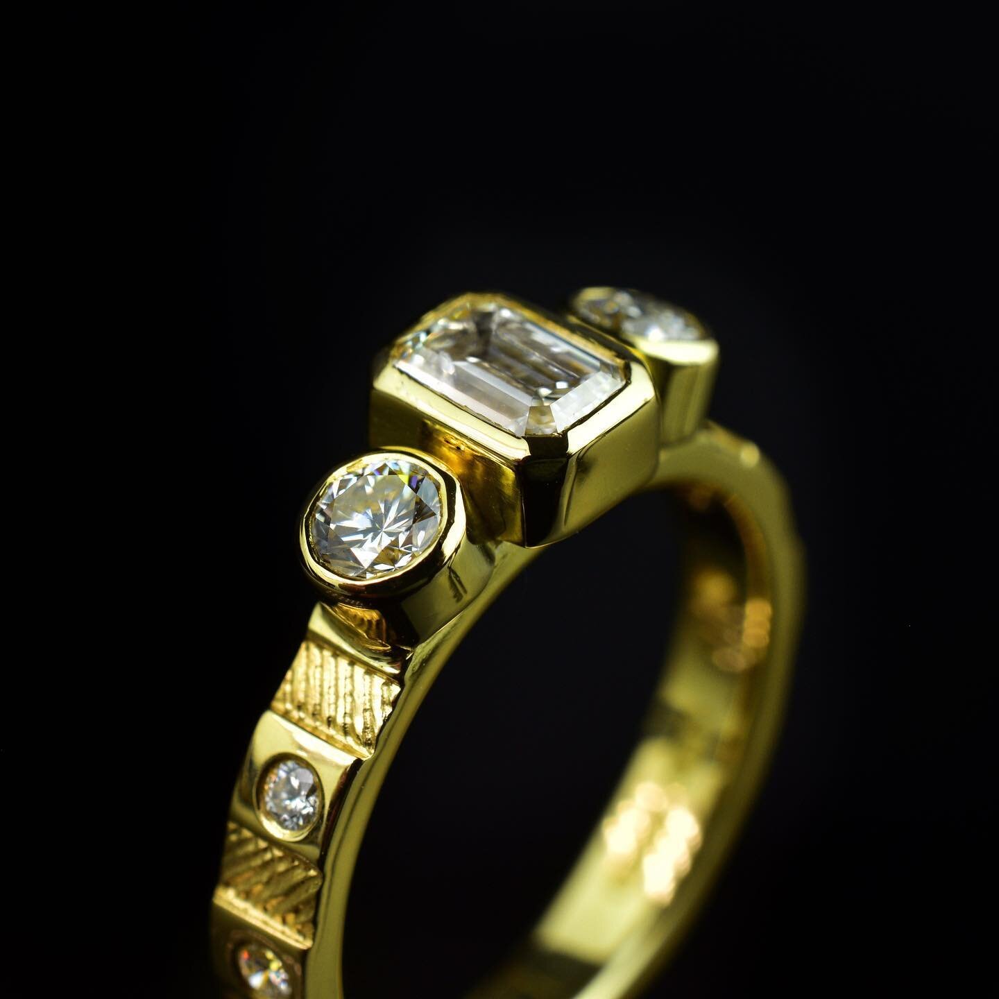 A closer look at this lovely custom ancient treasure ring. 

Hand fabricated and hand engraved in remodelled 18ct yellow gold. The band has our classic stepped design with engraved pattern and flush set diamonds.
It features a stunning D colour VS1 E