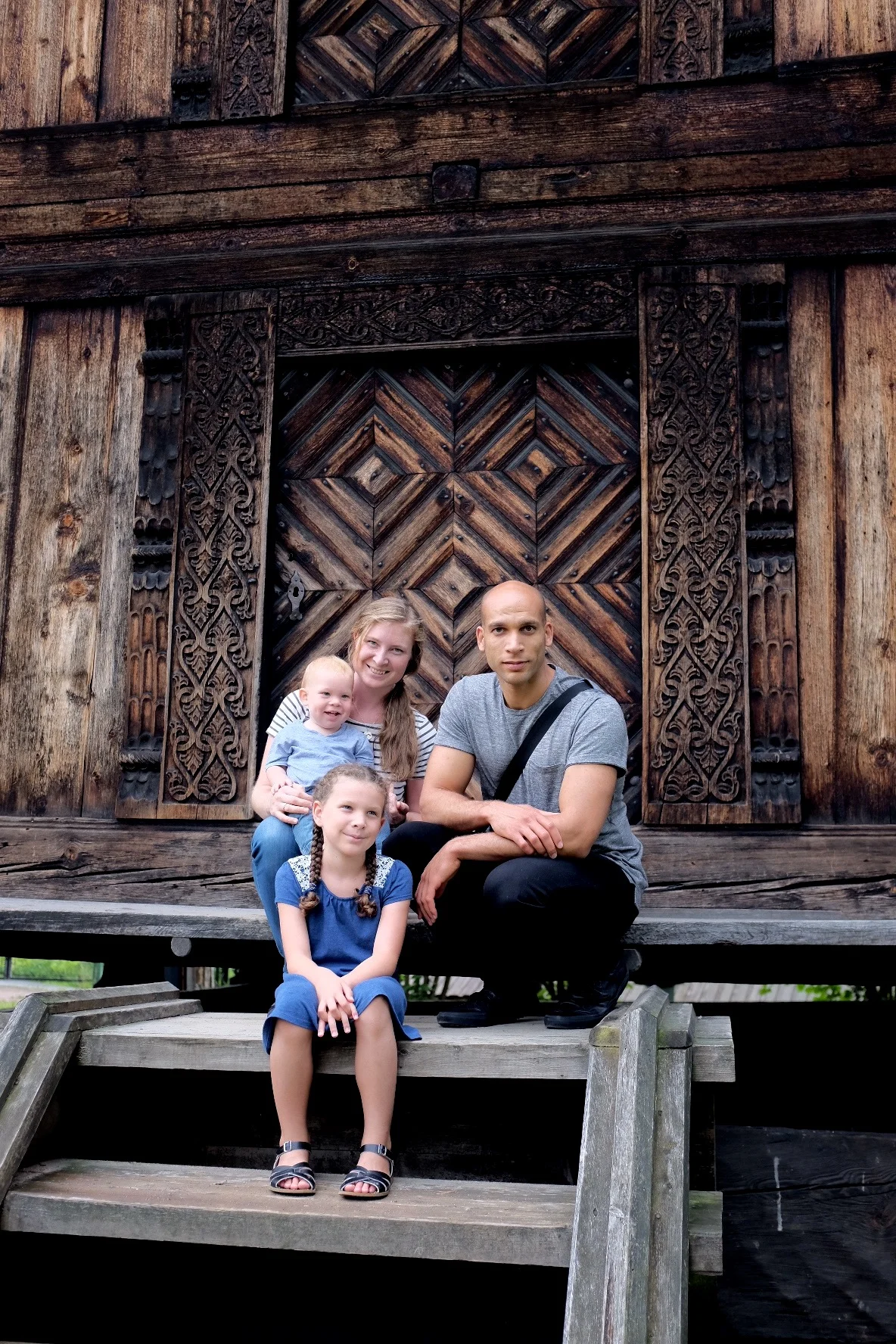Daniel, Janel & Co posing by a traditional Norwegian house in Oslo.