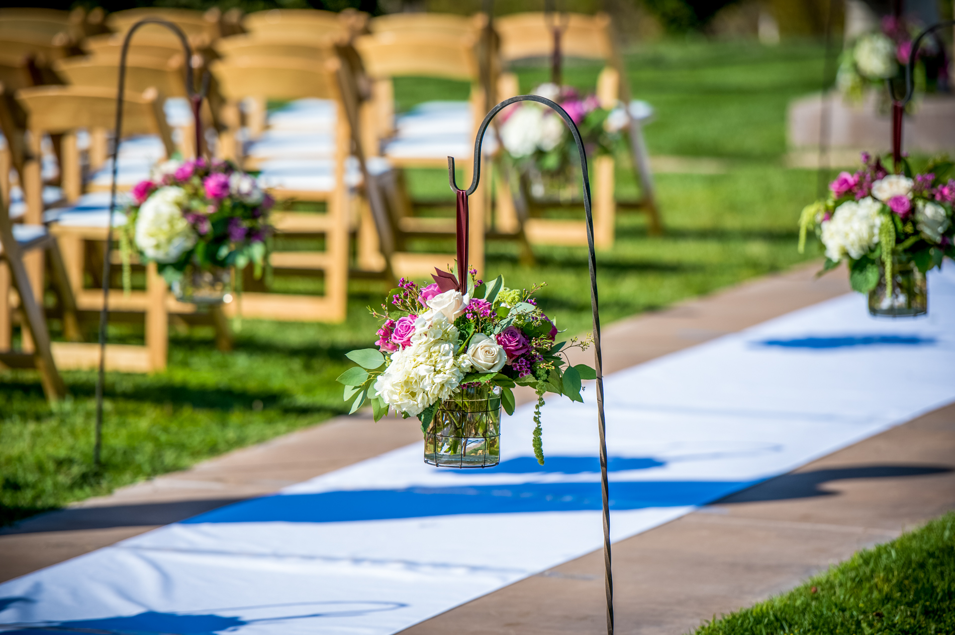 Shepard hooks line the main aisle of the ceremony grounds where flowers can be hung.