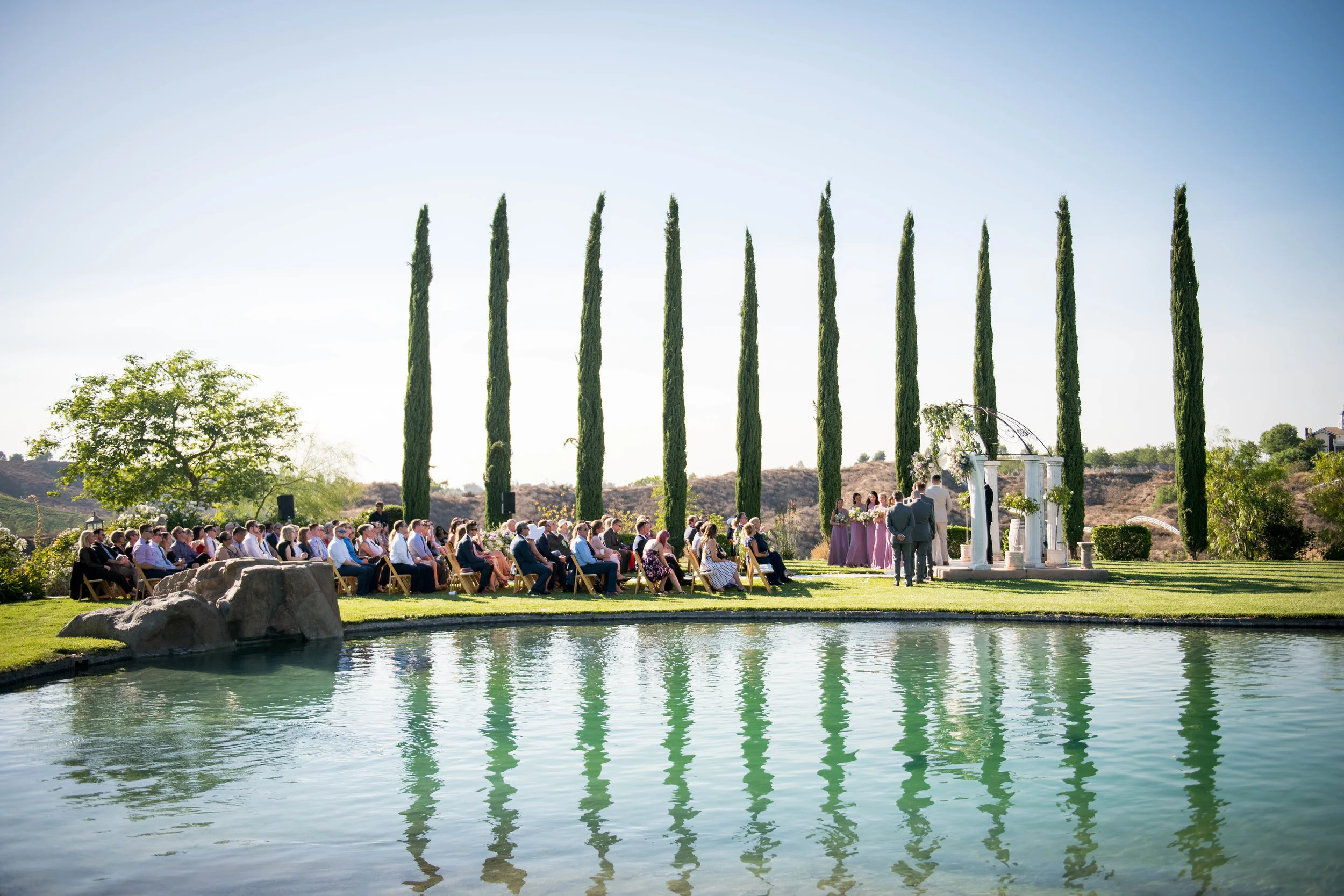 A view across the pond of a wedding in-progress.
