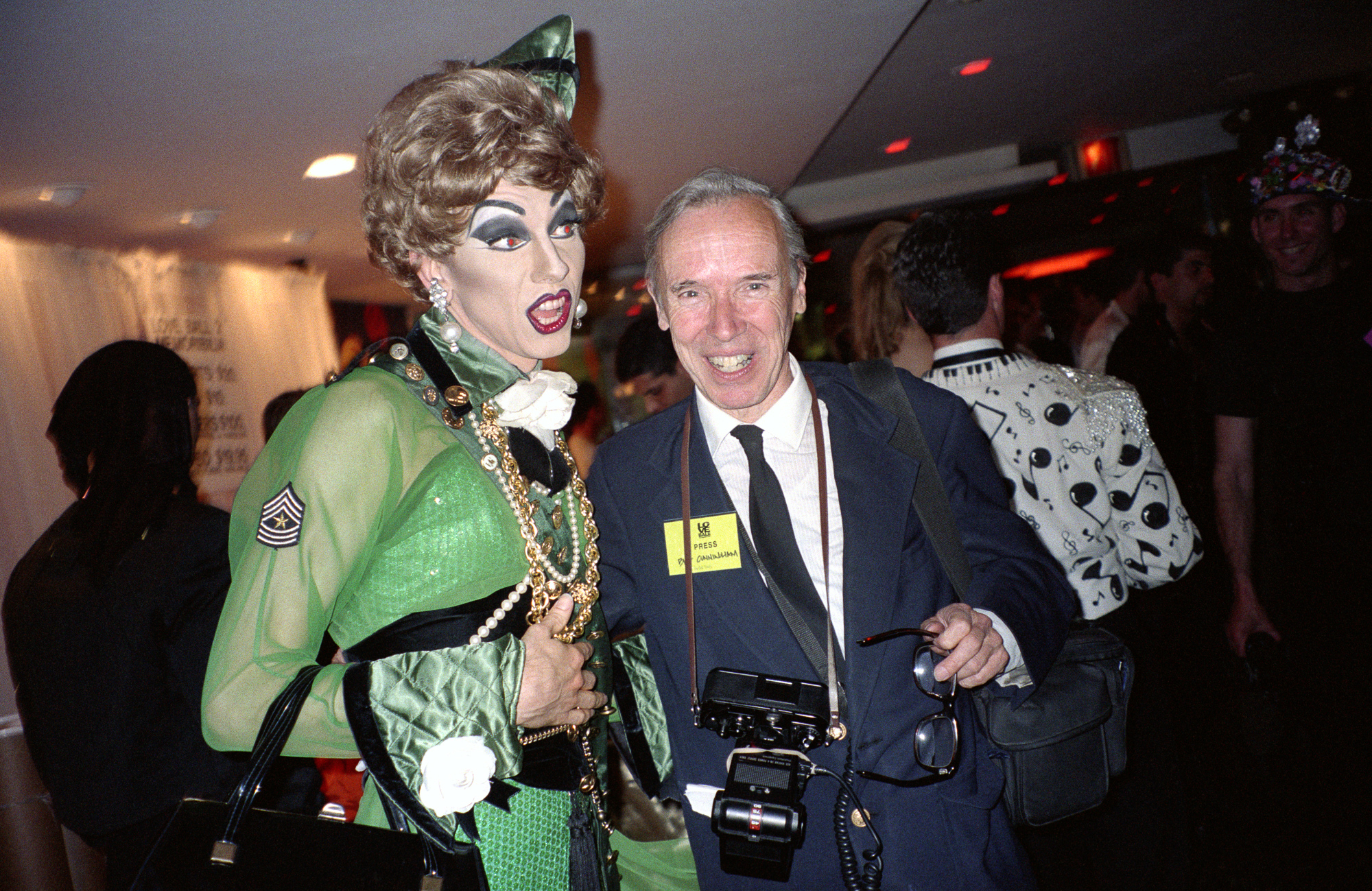  Performance artist John Epperson, AKA Lypsinka, with photographer Bill Cunningham at the Love Ball, Susanne Bartsch’s benefit for the Design Industries Foundation for AIDS. (1989) 