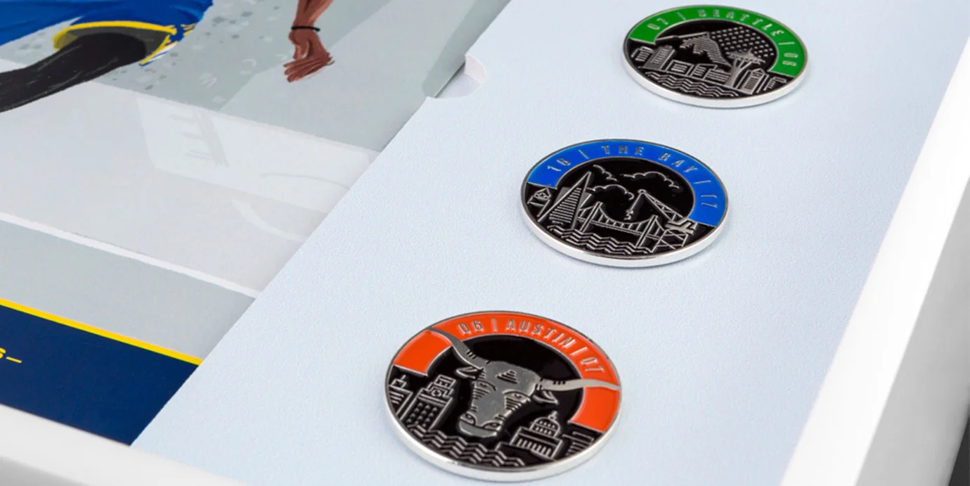 Enamel pins of each city.