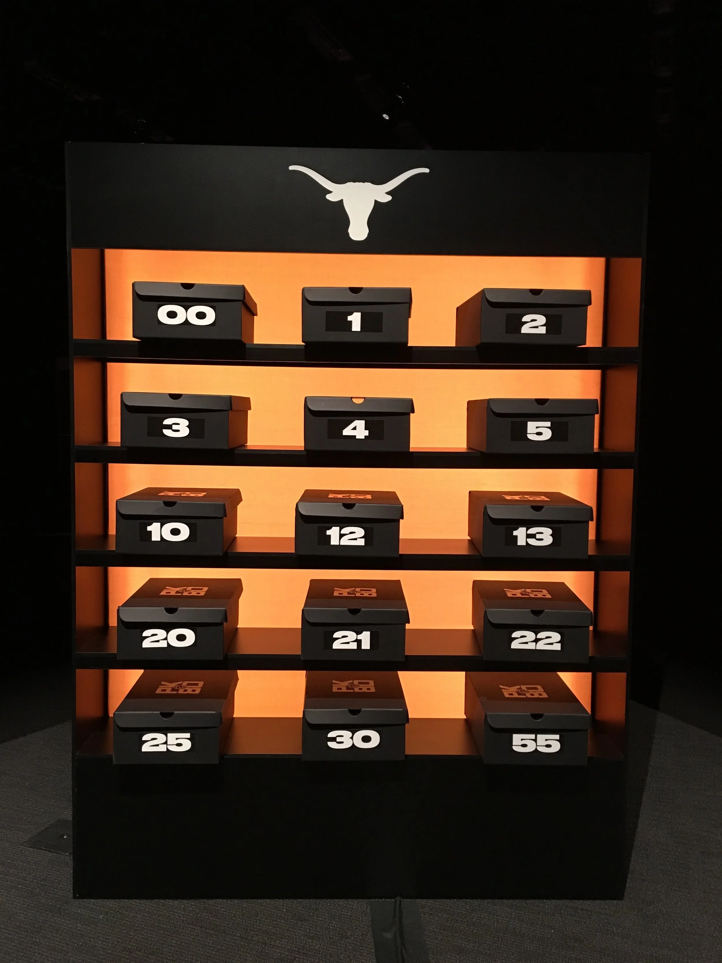 The backside of the lightbox housed sleek black boxes, custom with each athlete’s number and a fresh pair of LeBron 15s. 