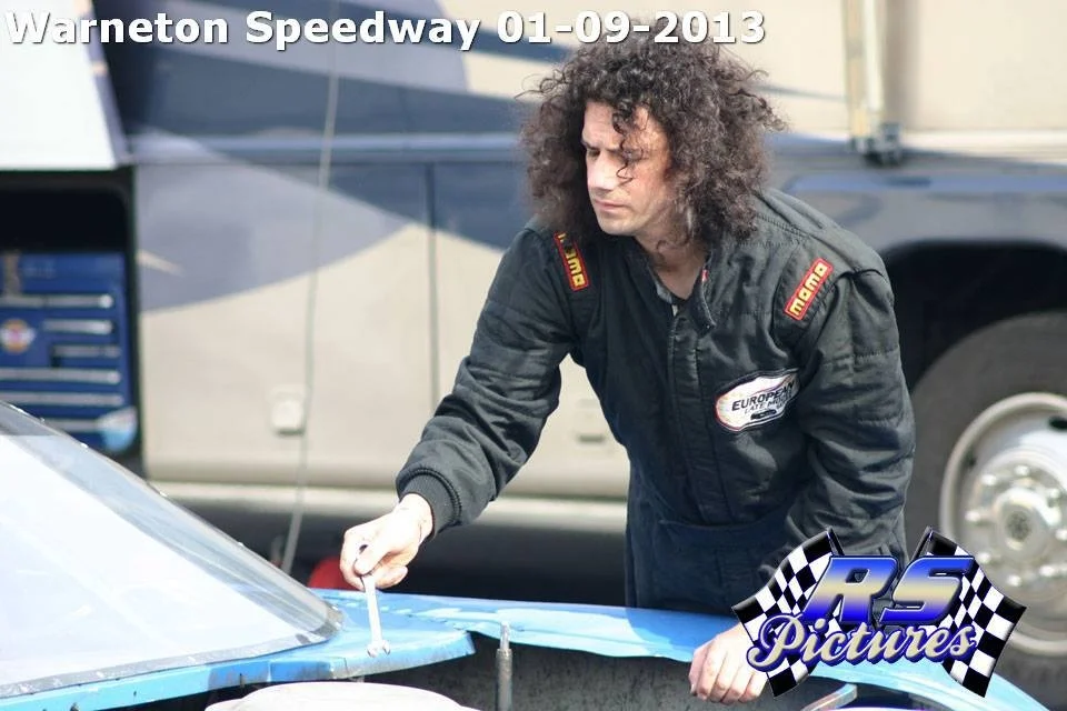 Looks like he's pretending to fix things to us . . . a staged photo?