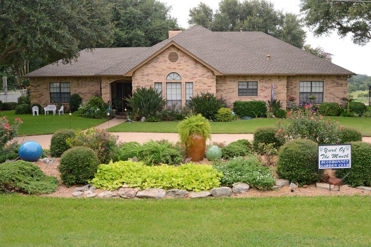 The Bluebonnet Garden Club Yard of the Month for September was awarded to Beverly and Larry Koehler at 2601 Mustang. The yard is beautifully landscaped with a rich variety of plants, such as bird of paradise, roses, crotons, dwarf yaupon, sweet potato vine, cedars, lantana and several varieties of ferns and shrubs. In addition to the plants in the flower beds, there were several beautiful pots and yard art spotted around which gave the flower beds an interesting dimension. There were trees on both sides of the house which offered shade and gave the yard a tranquil feeling.