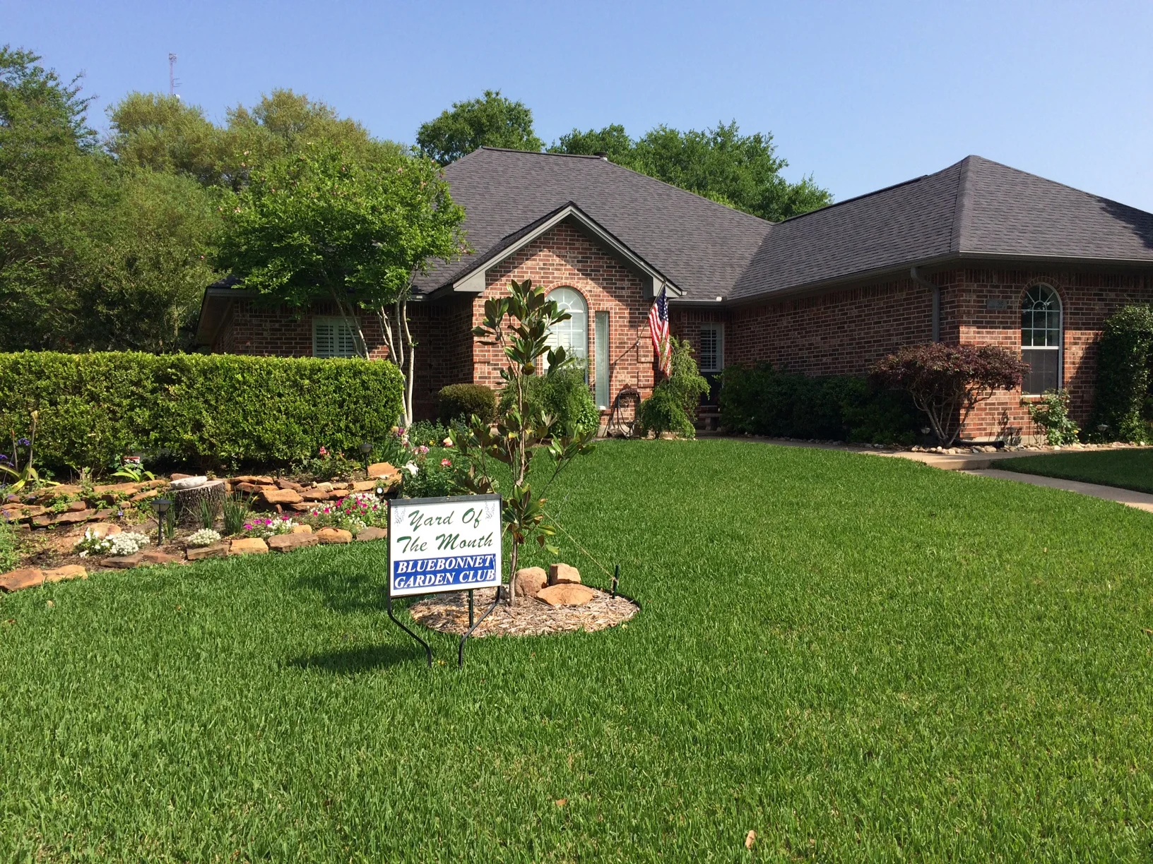 The Bluebonnet Garden Club awarded the Yard of the Month for April to Vincent and Mary DeSalvo at 505 Hickory Hollow, in Scenic Estates. The yard is wonderfully decorated with accent pieces such as a jasmine covered arbor, statuary & large boulders. Two large oak trees anchor the corner lot with native heat resistant plants. Weeping yaupon, camellia, plumbago, roses, gardenia, boxwood, and iris are just a few of the plants that enhance the landscape.