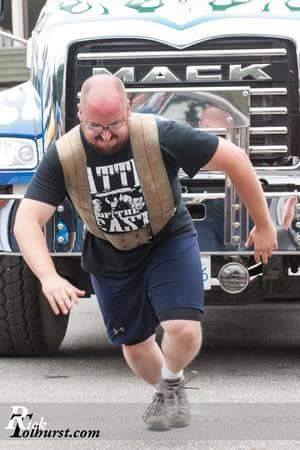 Joel pulls a truck in a strongman competition