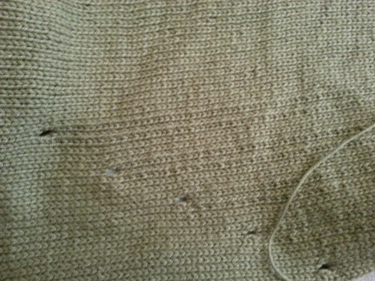 The eyelets showing where the dropped stitches will be on the back