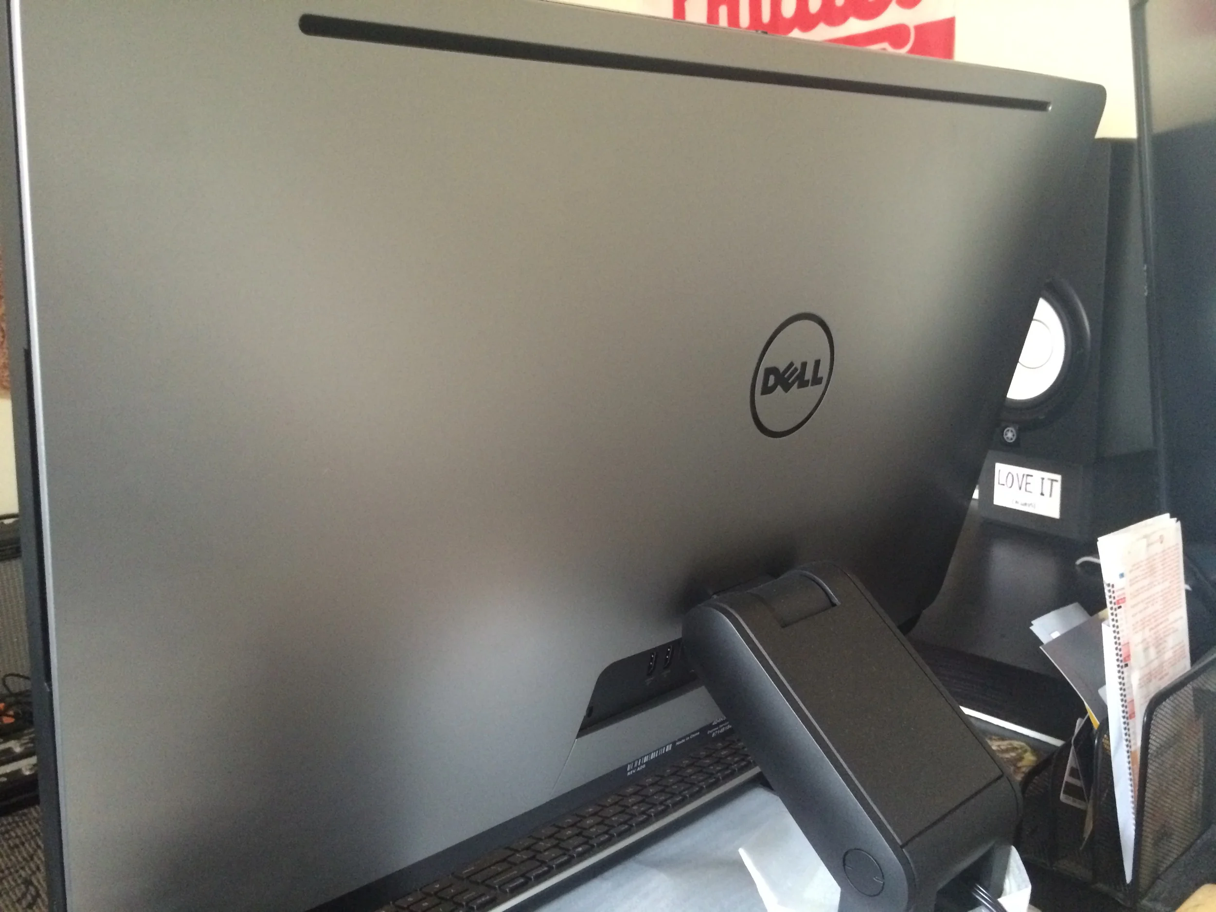 Behind the machine.