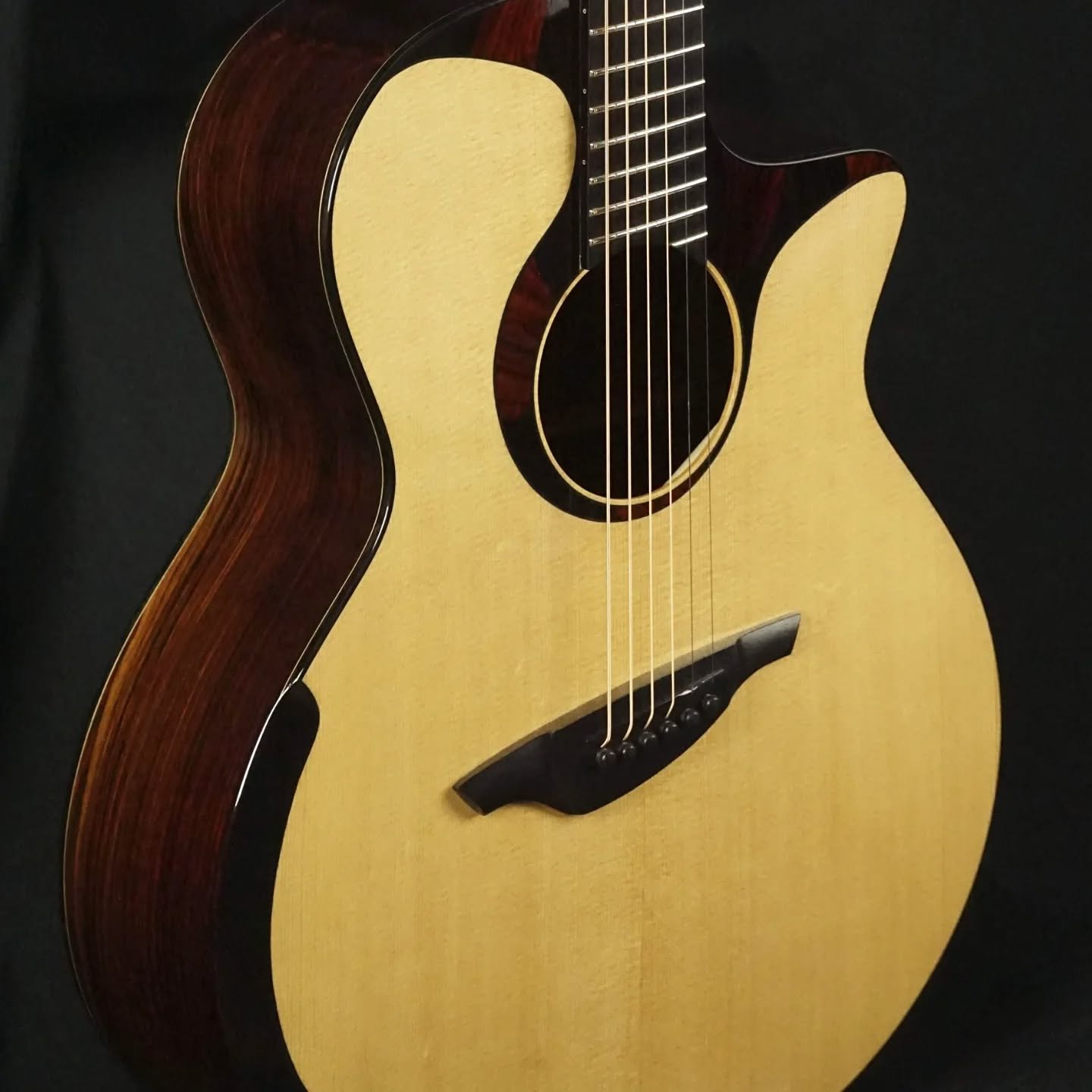 Here's the last two guitars that went out. They got some photos taken. You can see my shooting setup is just some black cloth hung over my orange chairs.  These were guitars from opposite sides of my building spectrum; a multi scale steel string and 