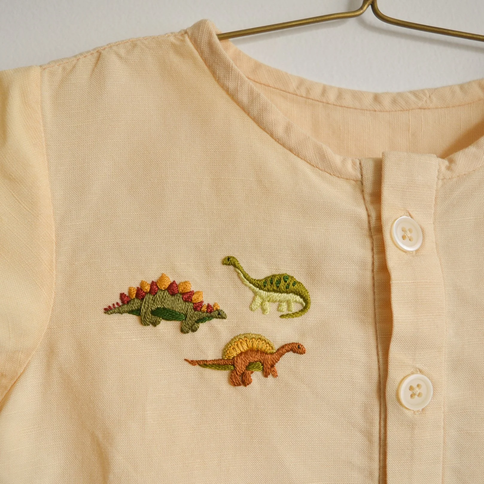 An Up-cycled Dinosaur Embroidered Baby Shirt