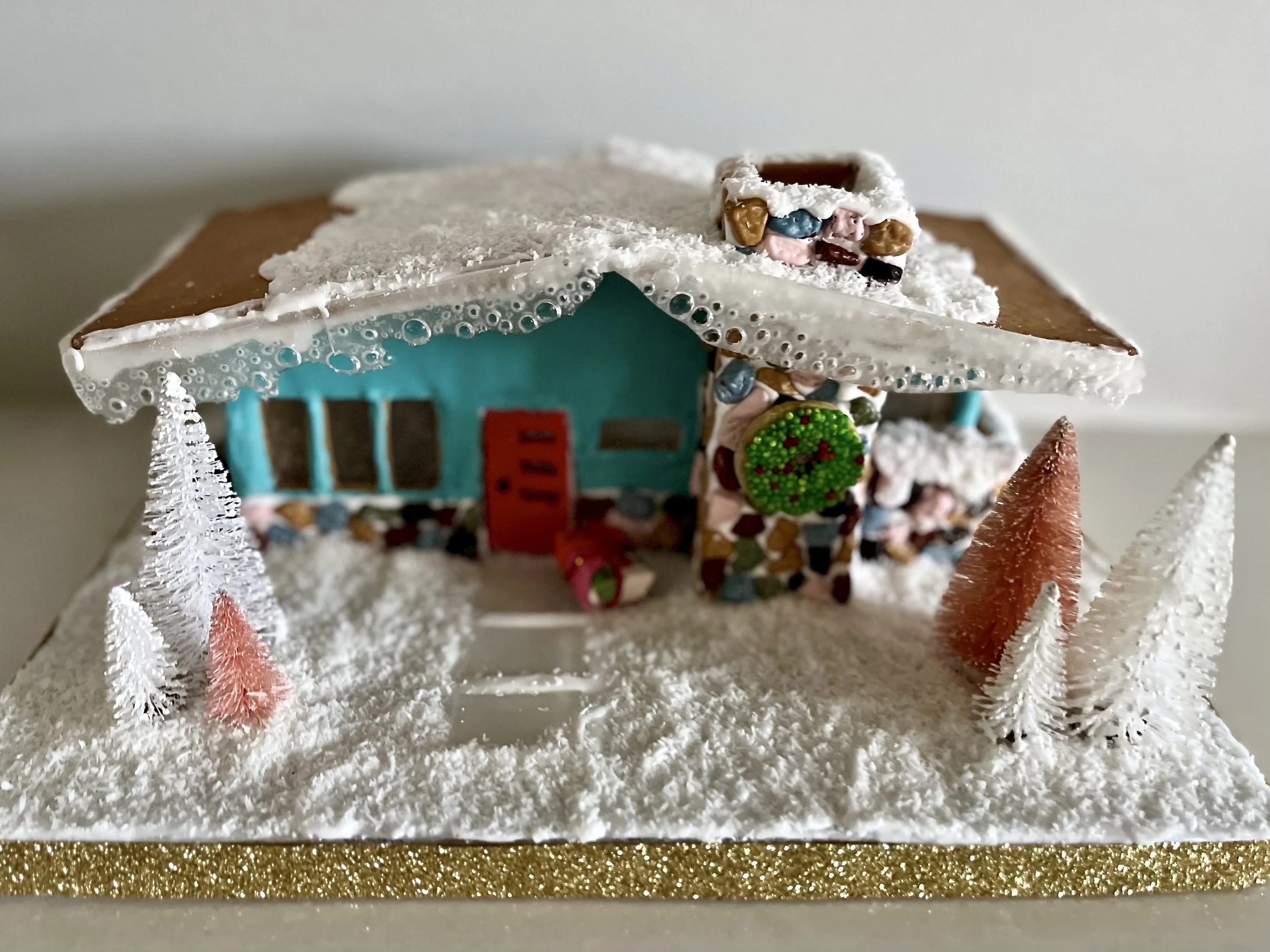 A turquoise mid-century gingerbread house