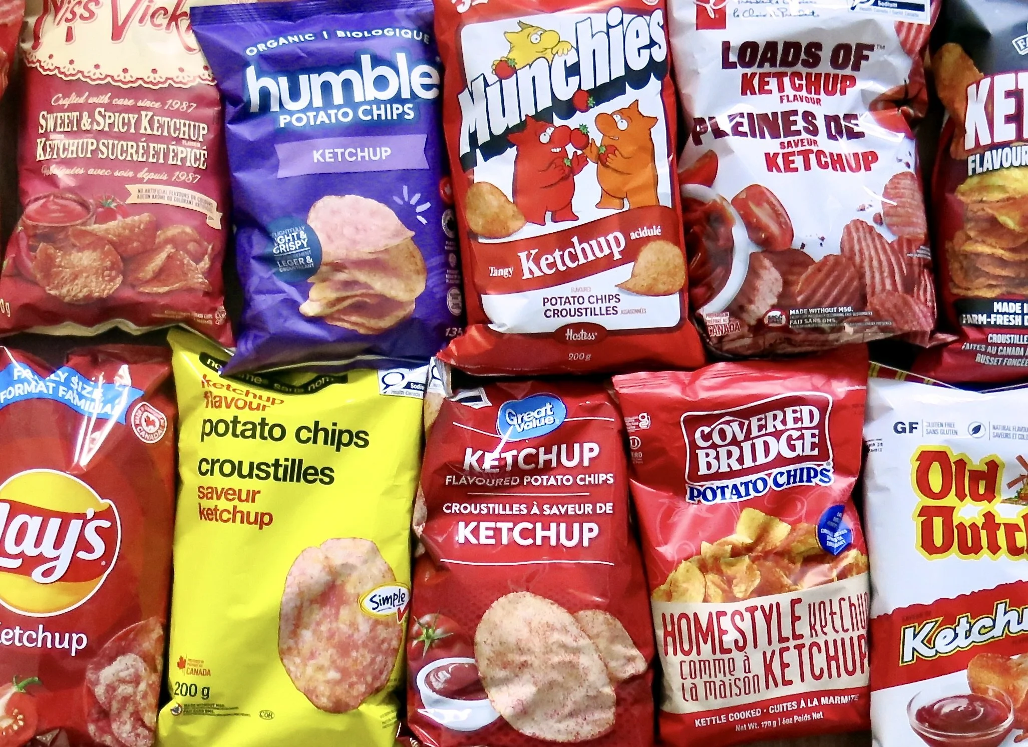 An assortment of brand name ketchup potato chip bags.