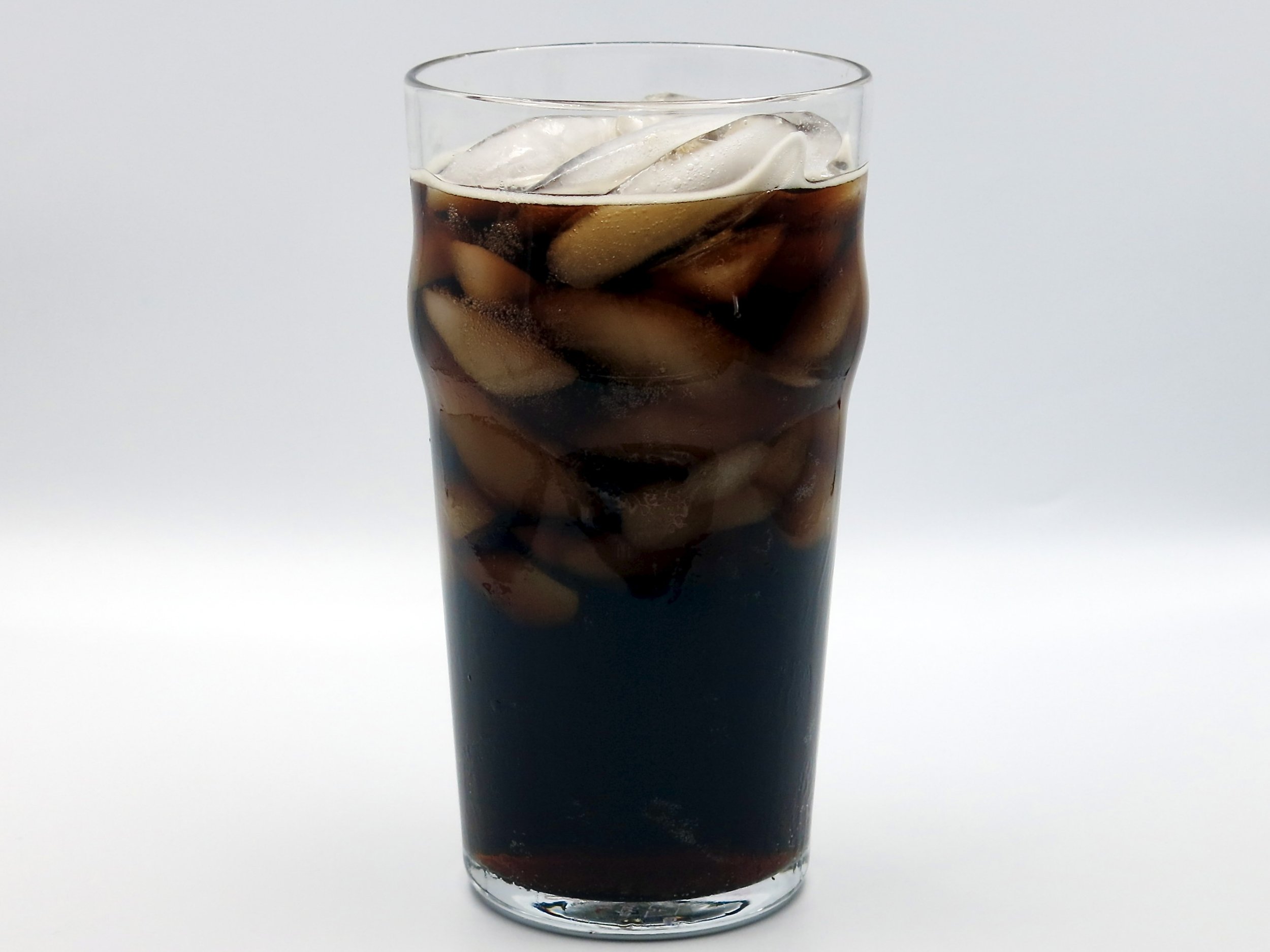 A glass of Thirsty Buddha Vintage Cola.