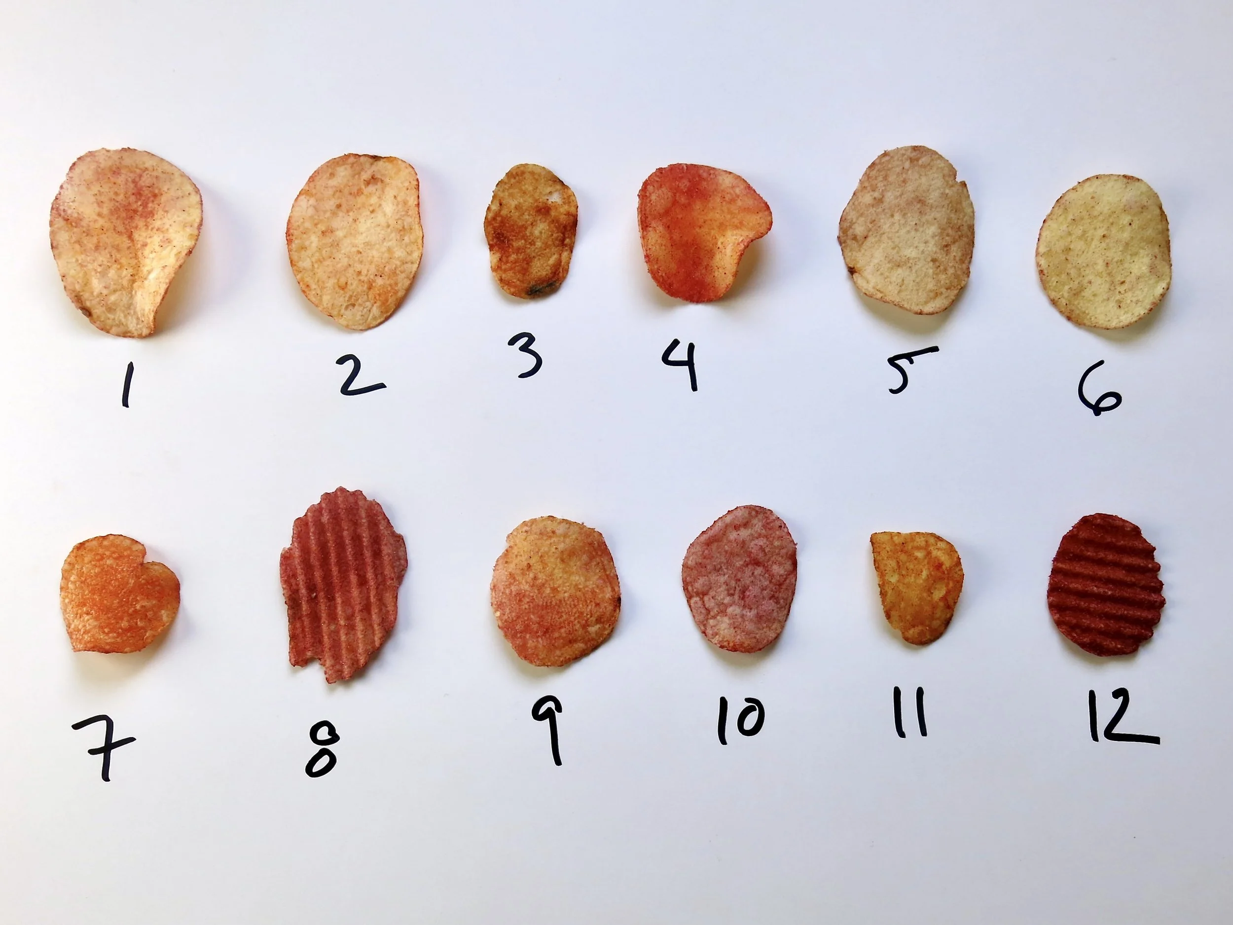An assortment of ketchup potato chips, numbered 1 to 12.